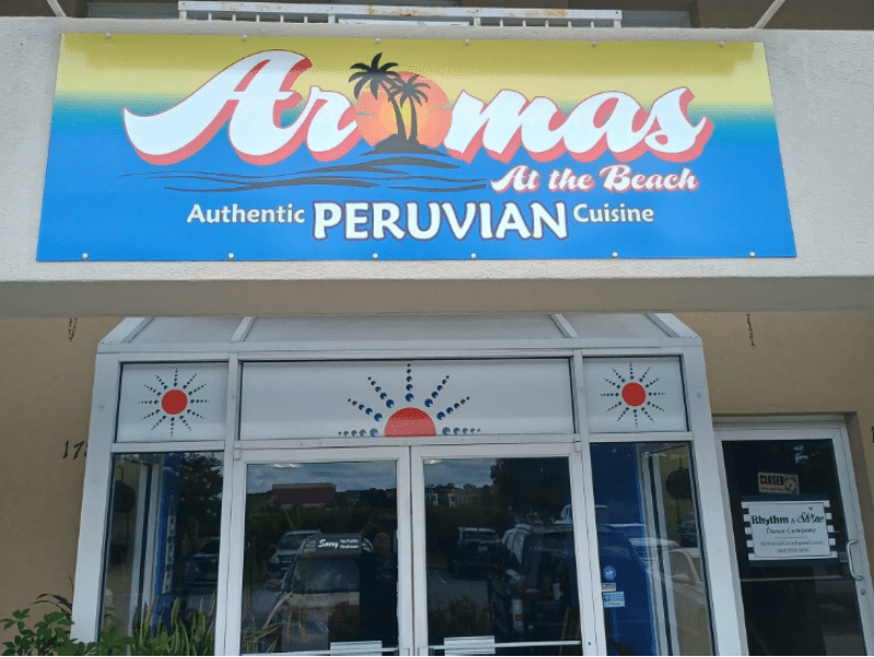 A restaurant with an advertisement for aromas at the beach.
