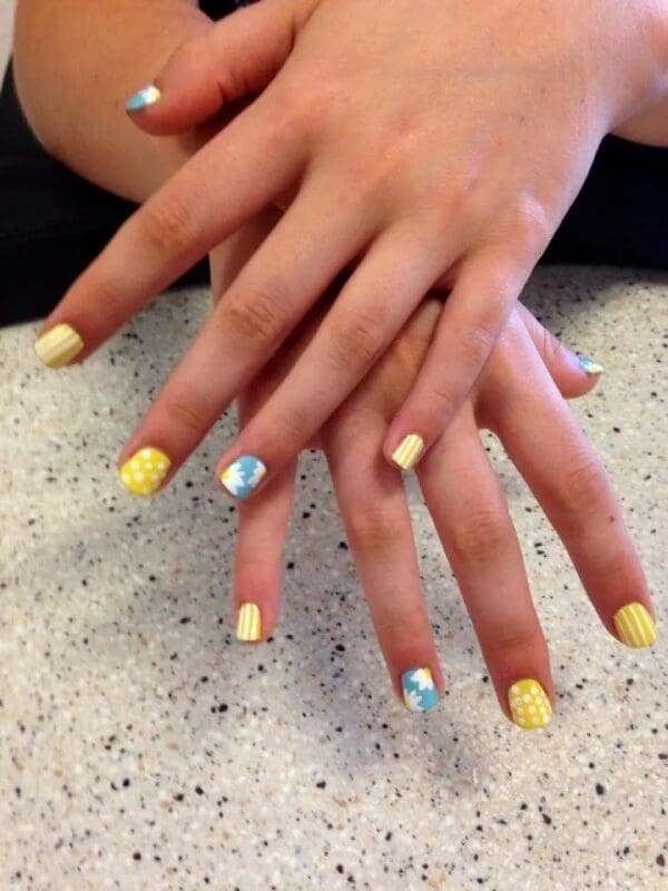 A close up of some hands with different nail designs