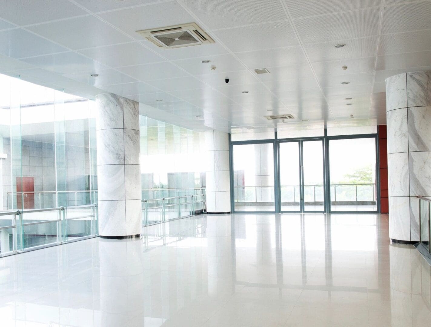 A large white room with glass doors and windows.