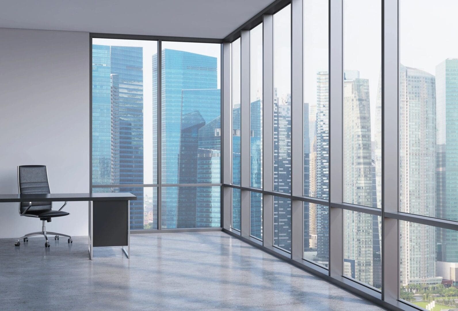 A room with large windows and a desk in it.