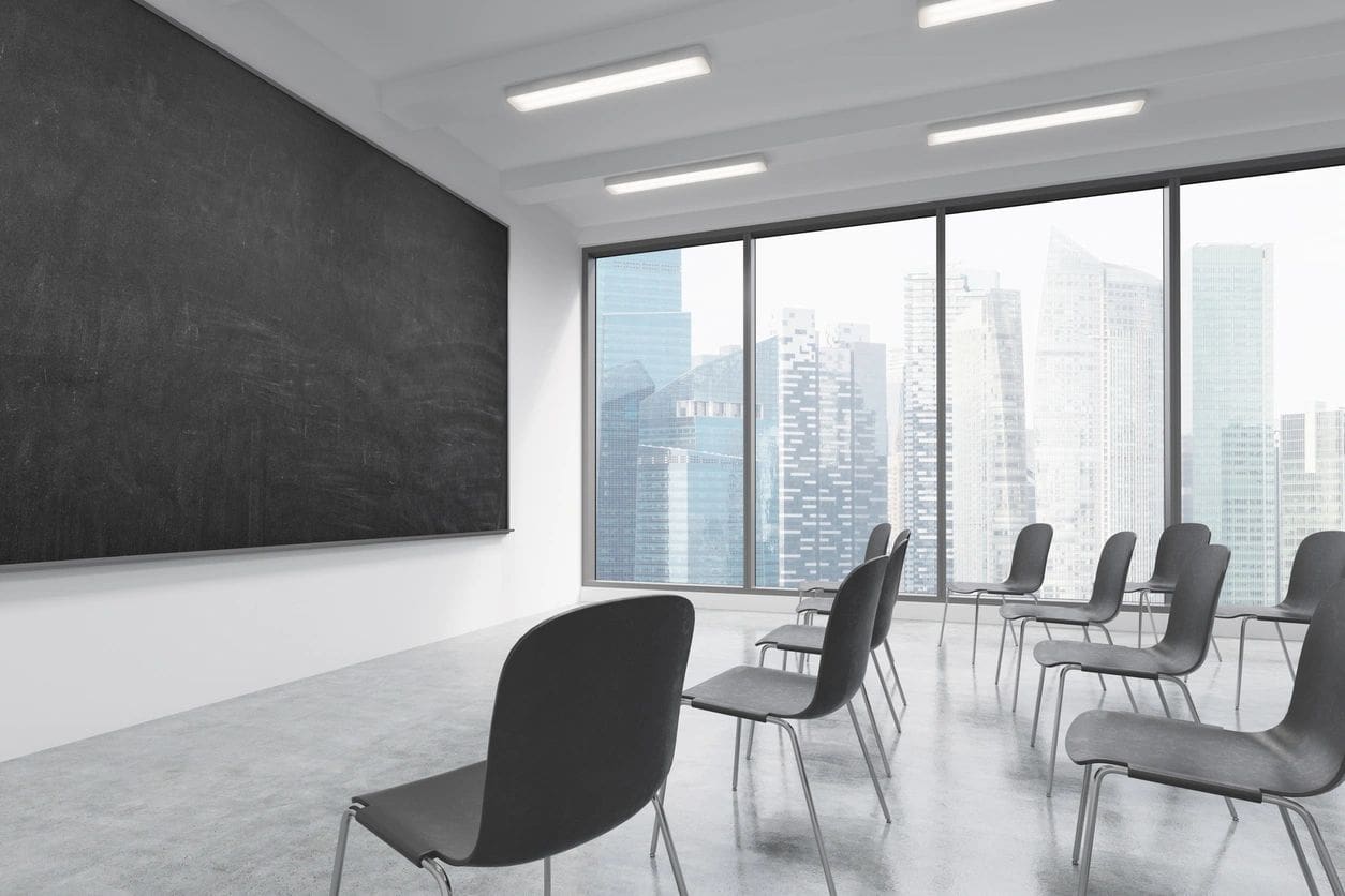 A room with chairs and a chalkboard in it