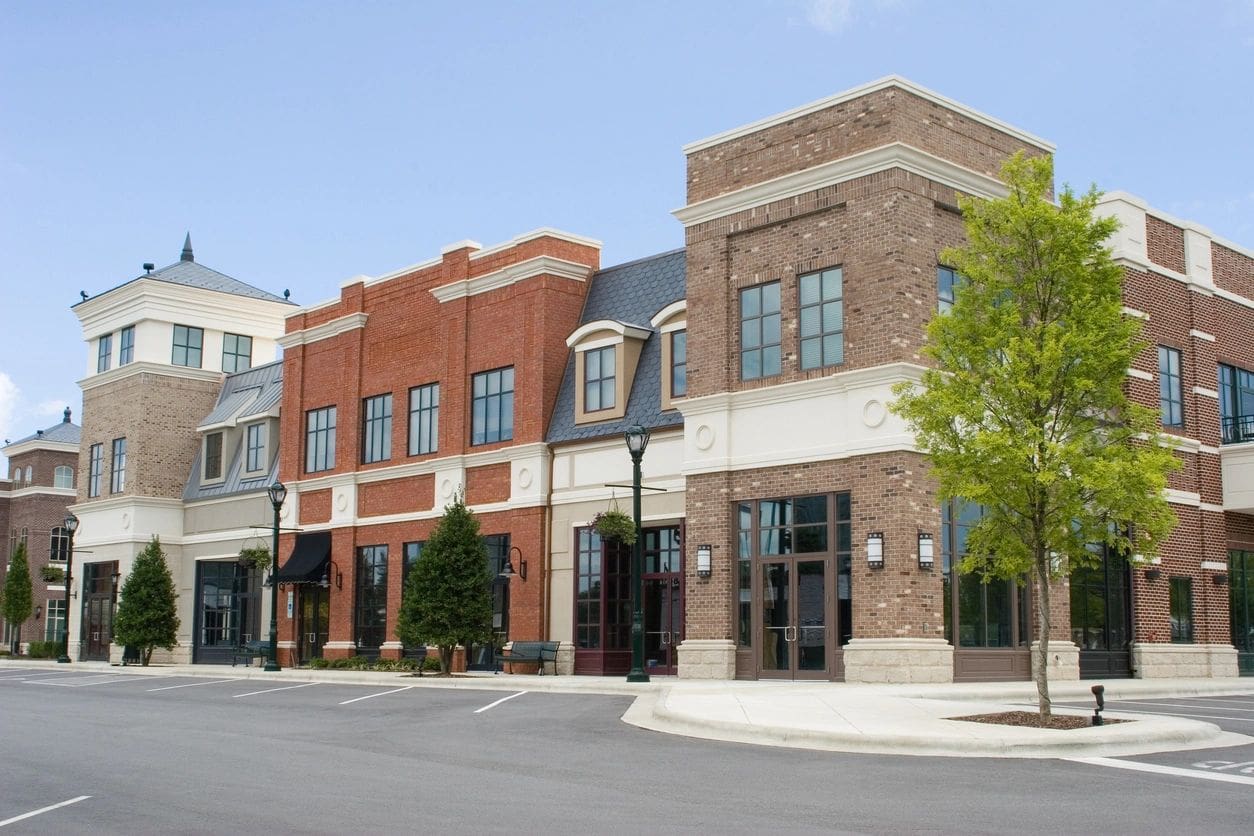 A row of brick buildings on the corner of a street.