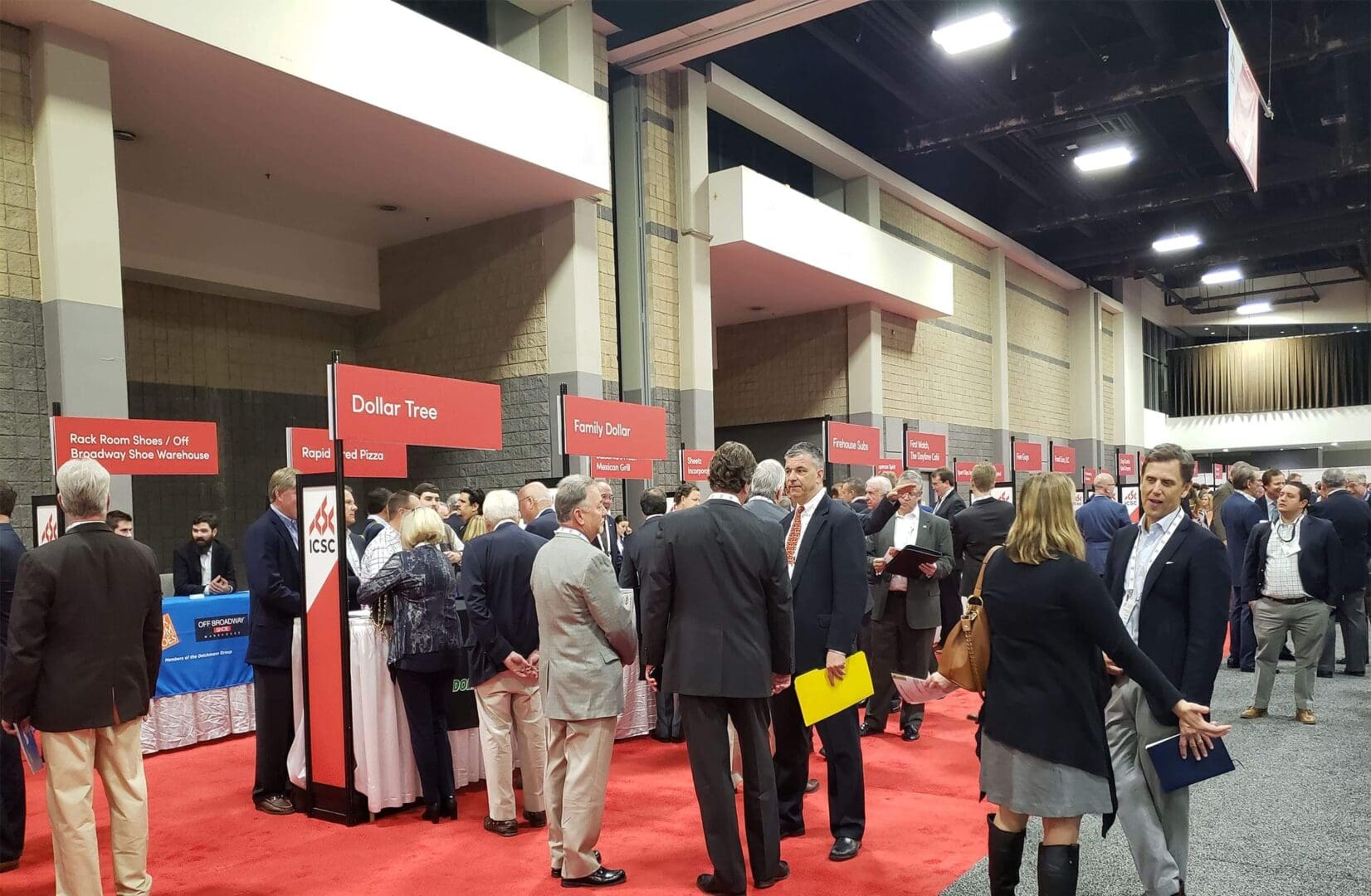 ICSC Charlotte 1 A crowd of people standing around in an event.