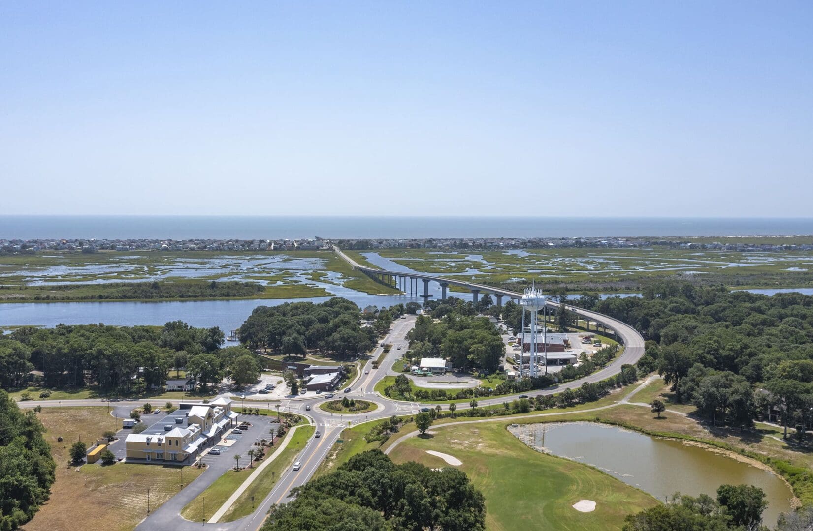 SUNSET BLVD N DEV-22 copy A view of the water from above shows a highway, golf course and marina.