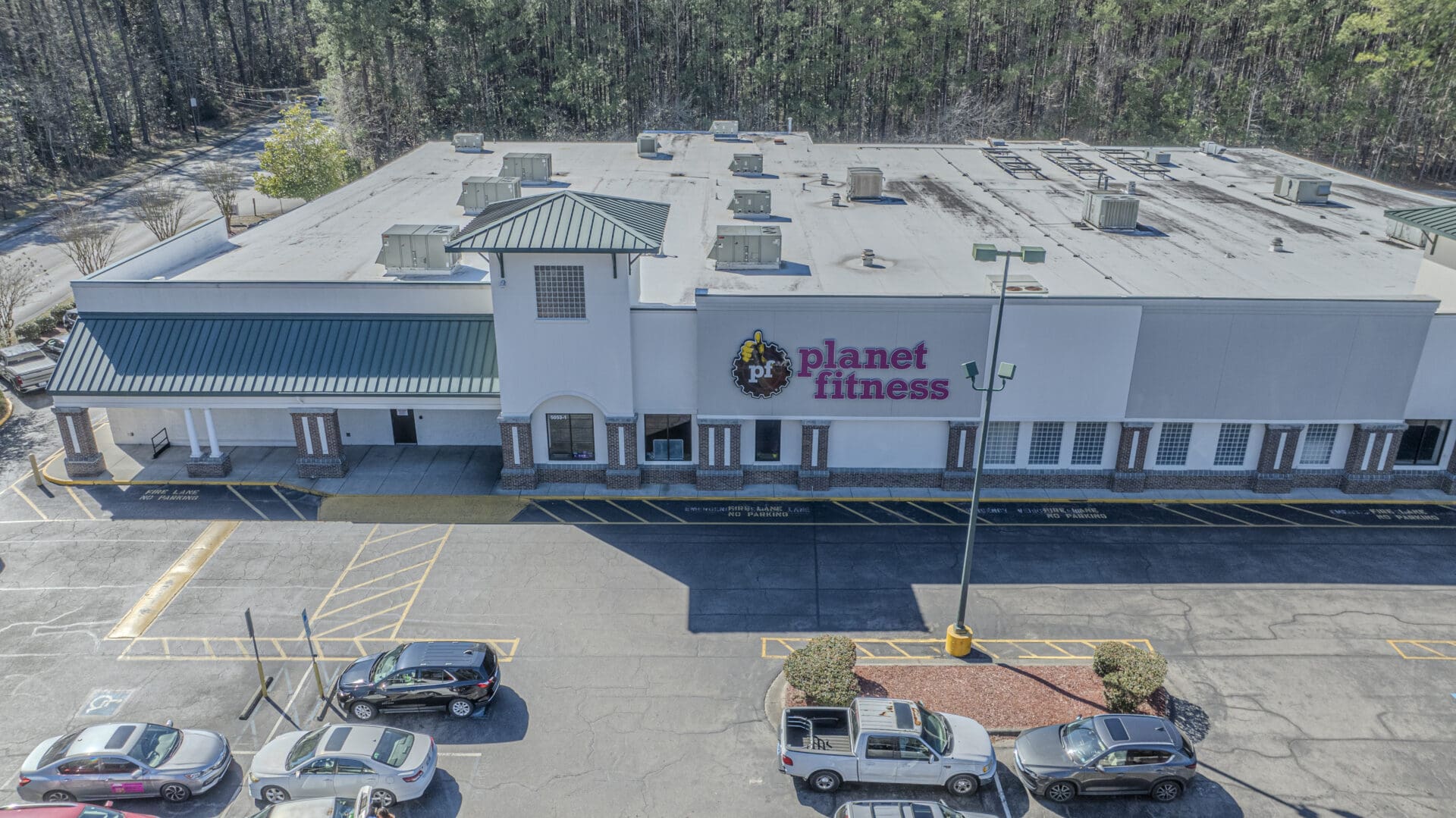 SHALLOTTE COMMONS 2-7-2024-34 Aerial view of Planet Fitness building exterior.