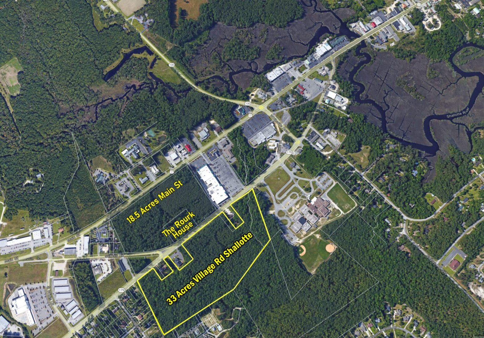 33 Ac Aerial w Parcels Labeled Aerial view of urban development and forest.