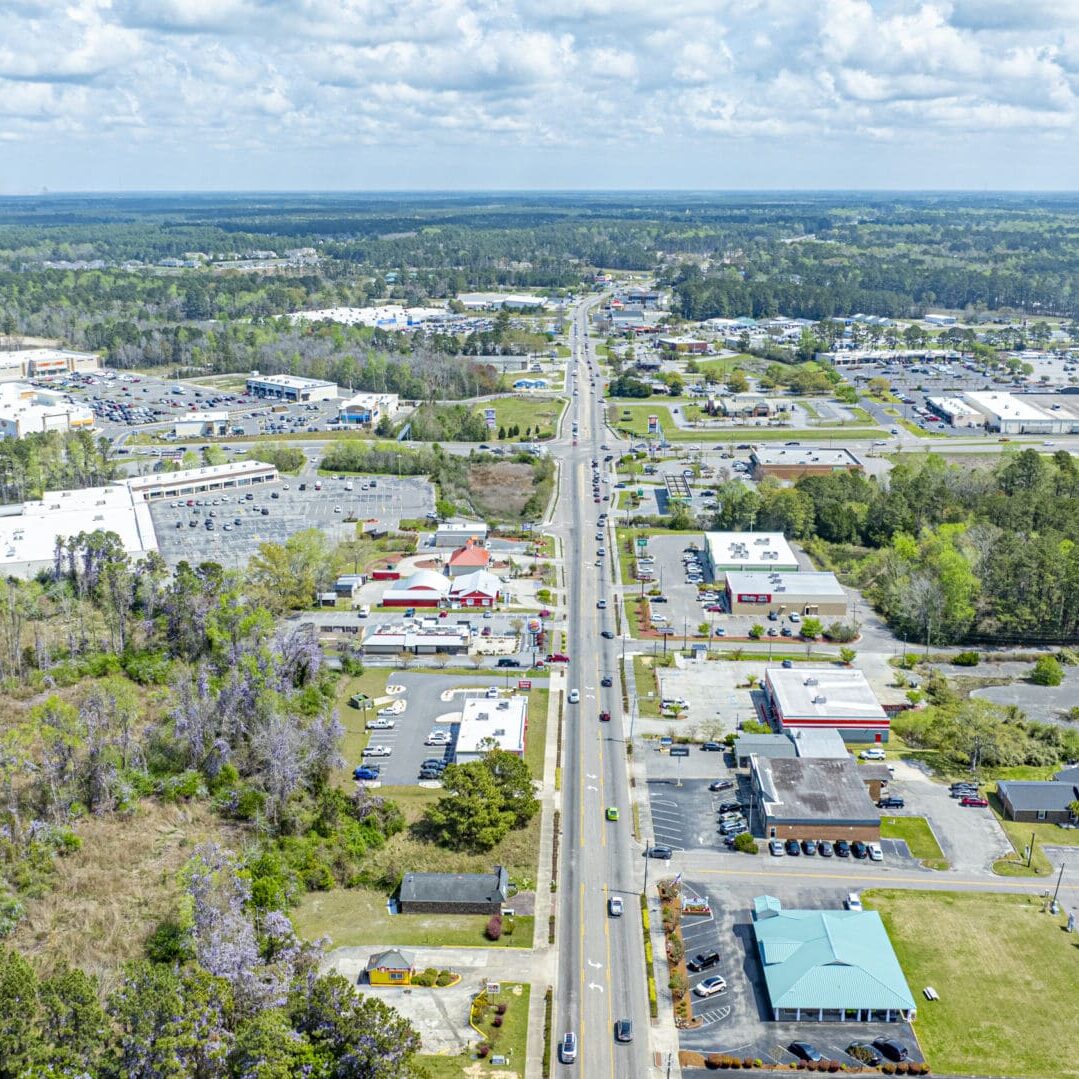 SHALLOTTE CENTERS-40 Aerial view of road and surrounding landscape.